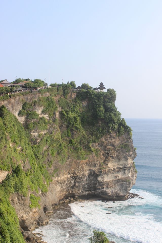 View of the dramatic cliffs and ocean at Uluwatu Temple, Bali.